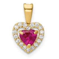 A gold heart-shaped pendant with a faceted ruby center stone surrounded by a halo of round diamonds, suspended from a gold bail.