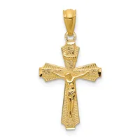 A gold crucifix pendant with detailed texturing on the arms and corpus, shown hanging from a bale against a white background.