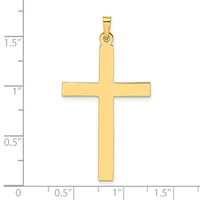 A gold cross pendant shown against a ruler measuring approximately 1.5 inches in height and 1 inch in width.