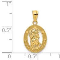 Gold oval pendant featuring Saint Christopher carrying a child, with textured border and engraved text around the rim, shown next to a ruler for scale.