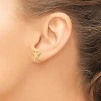 A person wearing a small gold star-shaped stud earring in their earlobe, shown in profile view.