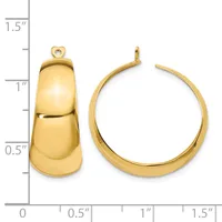 Two gold-toned earrings displayed next to a measurement scale: a chunky tapered hoop with a small loop attachment on the left, and a curved open hoop on the right.