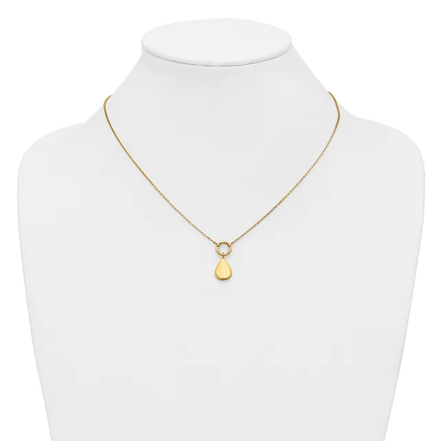 A gold-toned necklace with a delicate chain featuring a small circular connector and a smooth teardrop-shaped pendant, displayed on a white mannequin bust.
