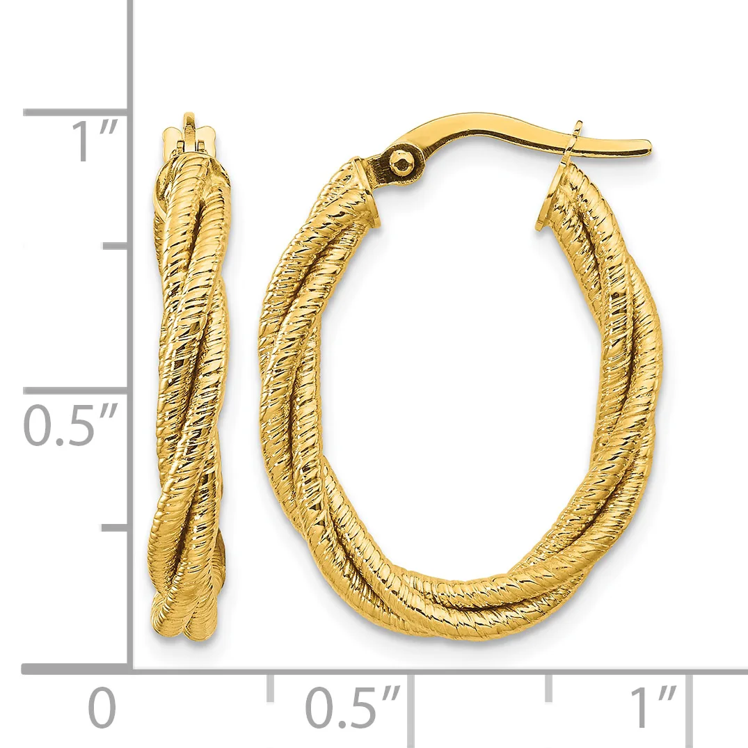 A pair of gold twisted hoop earrings with textured surfaces, shown next to a measurement ruler indicating approximately one inch in length.