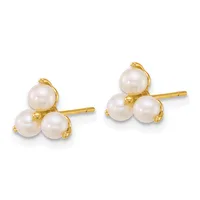 A pair of gold stud earrings, each featuring three white pearls arranged in a clustered design on a gold post.