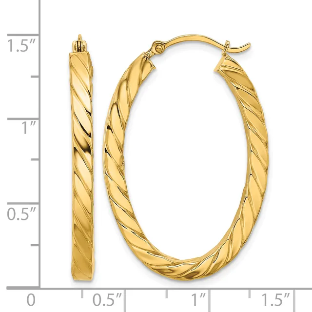 Gold twisted oval hoop earrings displayed against a measurement scale showing approximately 1.25 inches in height and 0.75 inches in width.