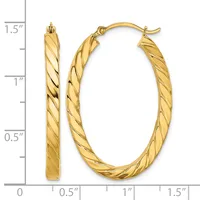 Gold twisted oval hoop earrings displayed against a measurement scale showing approximately 1.25 inches in height and 0.75 inches in width.