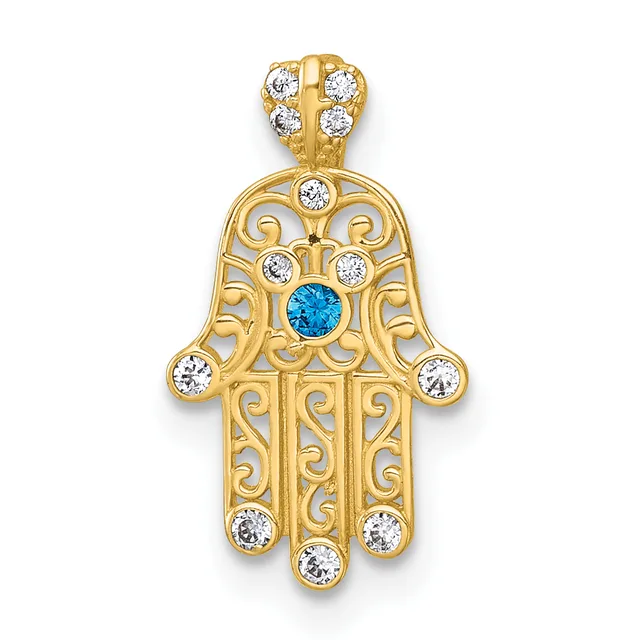 Gold hamsa hand pendant with ornate scrollwork design, featuring a blue topaz center stone surrounded by white cubic zirconia accents and a matching bail.