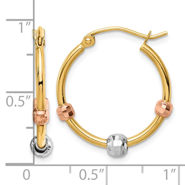 A pair of gold hoop earrings with rose gold and white gold accents and a measurement scale showing approximately one inch in length.
