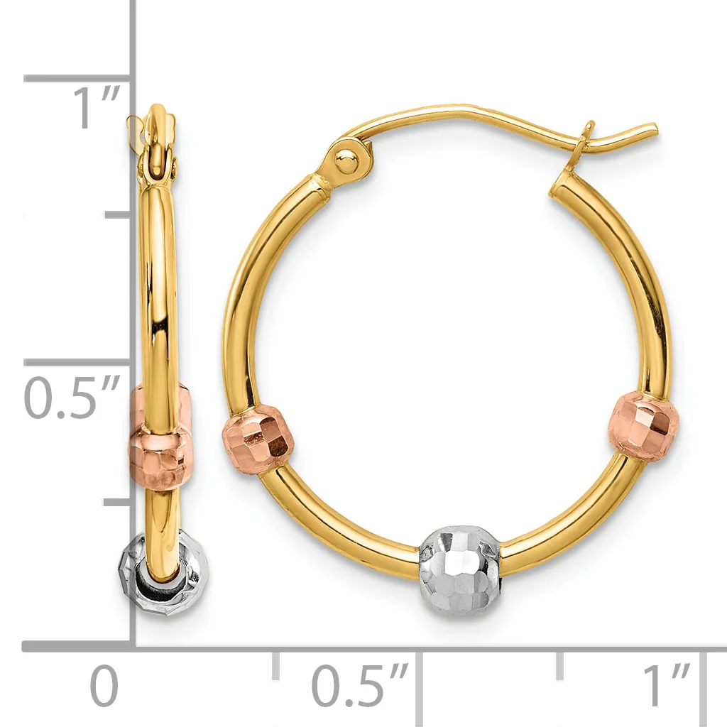 A pair of gold hoop earrings with rose gold and white gold accents and a measurement scale showing approximately one inch in length.