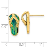 A pair of gold flip-flop shaped earrings with green and blue enameled soles and textured gold straps, shown next to a measurement scale.