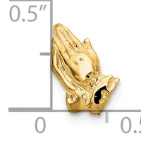 Gold praying hands charm with a small black stone accent, shown next to a ruler indicating it measures approximately 0.5 inches tall.