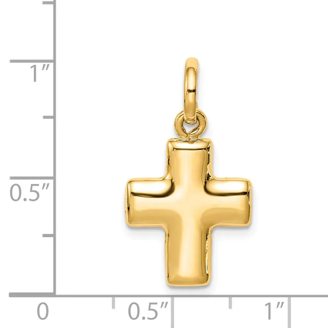 A gold cross pendant with rounded edges and a polished finish, shown against a measurement scale indicating approximately one inch in height.