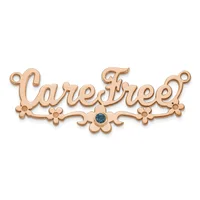 Rose gold decorative connector pendant with scrollwork and floral details, featuring a small blue gemstone in the center and loops at each end.