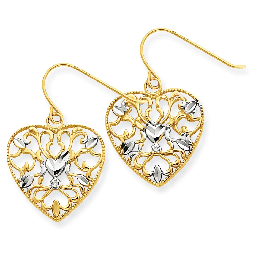 Pair of gold and silver filigree heart-shaped dangle earrings with ornate scrollwork design and fish hook ear wires.