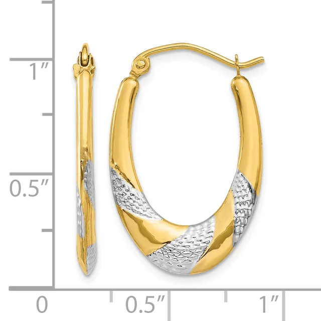 Pair of two-tone gold hoop earrings with textured white gold sections, shown next to a ruler measuring approximately one inch in length.