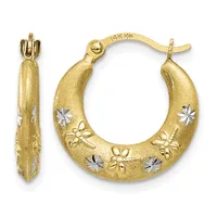 A pair of gold hoop earrings with a brushed finish, decorated with alternating flower motifs in white and yellow gold, shown from front and side views.