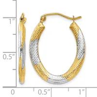 A pair of two-tone gold hoop earrings with textured surfaces, measuring approximately one inch in length, displayed against a measurement scale.