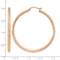 Rose gold textured hoop earrings with a ruler showing them approximately 1.75 inches in diameter and 3 millimeters thick.