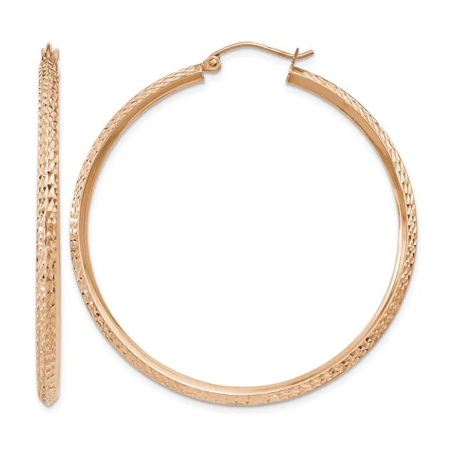 A pair of rose gold textured hoop earrings displayed flat and standing upright, showing the detailed surface pattern and hinged closure.