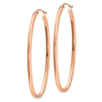 A pair of rose gold hoop earrings with a polished finish and hinged closures, displayed against a white background.
