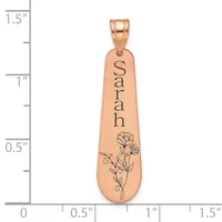 Rose gold pendant with the name "Sarah" engraved vertically and a floral design at the bottom, shown next to a measurement scale.
