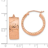 Rose gold textured hoop earrings displayed next to a measurement ruler, showing approximately one inch in diameter with a hammered finish surface.
