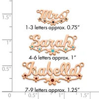 Three copper name pendants with decorative flourishes and gemstone accents, displayed with a size scale showing heights from approximately 0.75 to 1.25 inches.