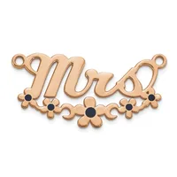 Rose gold-toned metal pendant with script lettering, decorative flower motifs with black stone centers, and two small loops at the top for attachment.