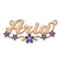 Rose gold pendant with script text and blue enamel flowers, featuring two loops at the top for attachment.