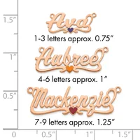 Three rose gold name charms with small heart accents shown against a ruler, ranging from approximately 0.75 to 1.25 inches in width.