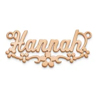 Rose gold-toned metal nameplate pendant spelling "Hannah" with decorative floral elements and small loops at the top corners for attachment.