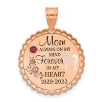 Rose gold circular pendant with scalloped edges, engraved text reading "Mom Always On My Mind Forever In My Heart 1929-2022," decorative roses, a red gemstone, and white wing design.