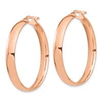 A pair of polished rose gold hoop earrings with a thick, rounded profile and post closures, displayed against a white background.