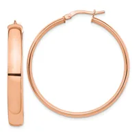 A pair of polished rose gold hoop earrings shown from the front and side view, featuring a chunky oval shape with a hinged post closure.