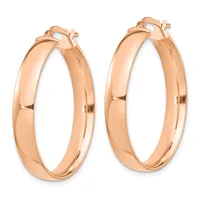 A pair of polished rose gold hoop earrings with a chunky, curved rectangular profile and clip-back closures, shown from the front.