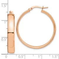 Rose gold hoop earrings with a polished finish and post backs, displayed next to a measurement scale showing approximately 1.25 inches in diameter.