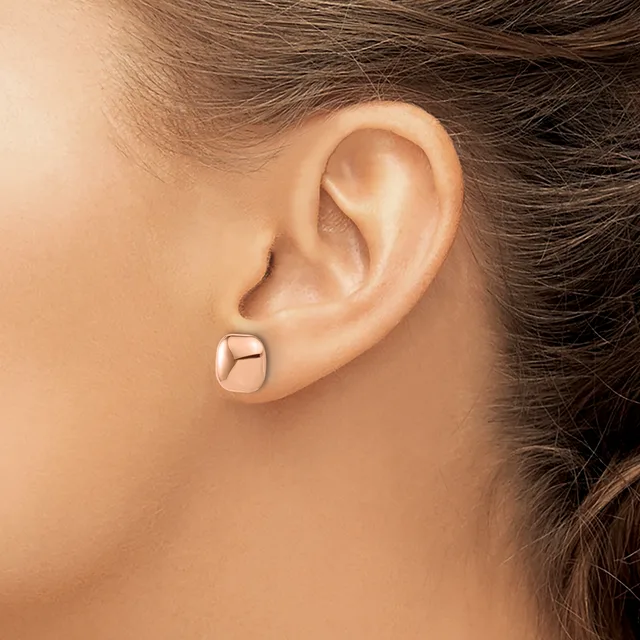 A person wearing a polished rose gold square stud earring is shown in profile, displaying the earring against their ear and neck.