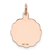 A rose gold scalloped circular charm with a small loop attachment at the top and a small stamped hallmark on the lower surface.