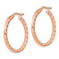 A pair of rose gold textured hoop earrings with rectangular surface details and hinged closures, displayed against a white background.