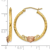 Pair of gold hoop earrings with textured finish and rose gold heart charms, shown against a ruler measuring approximately one inch in diameter.