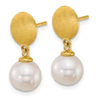 A pair of gold stud earrings with brushed oval tops and dangling white pearl spheres connected by small gold caps and loops.