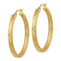 Pair of gold hoop earrings with a textured hammered finish and hinged post closures, displayed side by side.