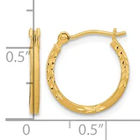 Pair of gold hoop earrings with textured diamond-cut surface and polished smooth sides, displayed with measurement scale showing approximately half-inch diameter.