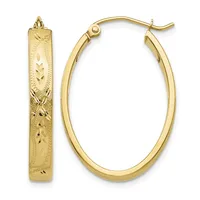 A pair of gold hoop earrings, one displayed flat showing an oval shape with etched decorative leaf patterns, the other shown at an angle displaying its polished curved surface.