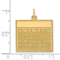 Gold calendar pendant showing months and dates with a decorative scalloped border, displayed against a measurement scale.