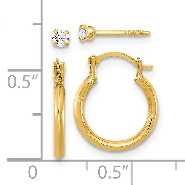 Two pairs of gold earrings displayed against a measurement scale: stud earrings with round clear stones and hoop earrings with a polished finish.