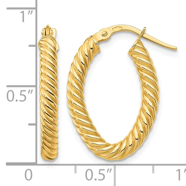 A pair of gold twisted oval hoop earrings with post and clutch backs, shown next to a ruler measuring approximately one inch in length and half an inch in width.