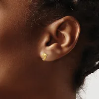 A gold curved crescent-shaped stud earring worn on the earlobe of a person shown in profile.