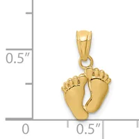 A gold baby feet pendant shown next to a ruler indicating its size is approximately half an inch wide and tall.